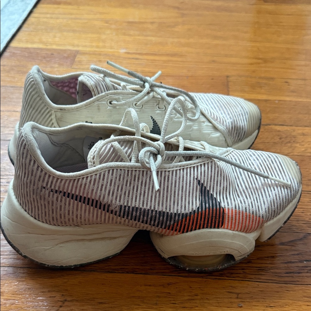 Nike Kids Beige Sneakers with Black and Orange Swoosh